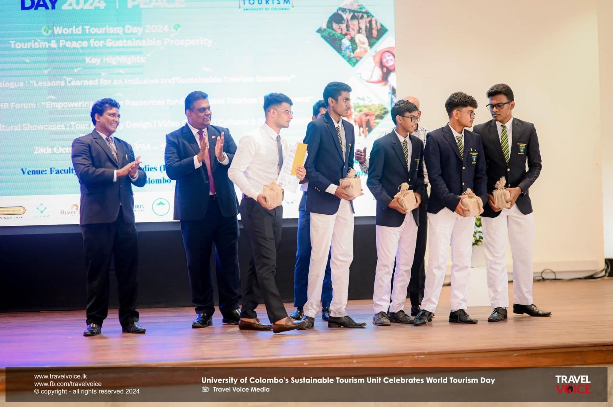 Receiving the award on stage at the University of Colombo's World Tourism Day ceremony.