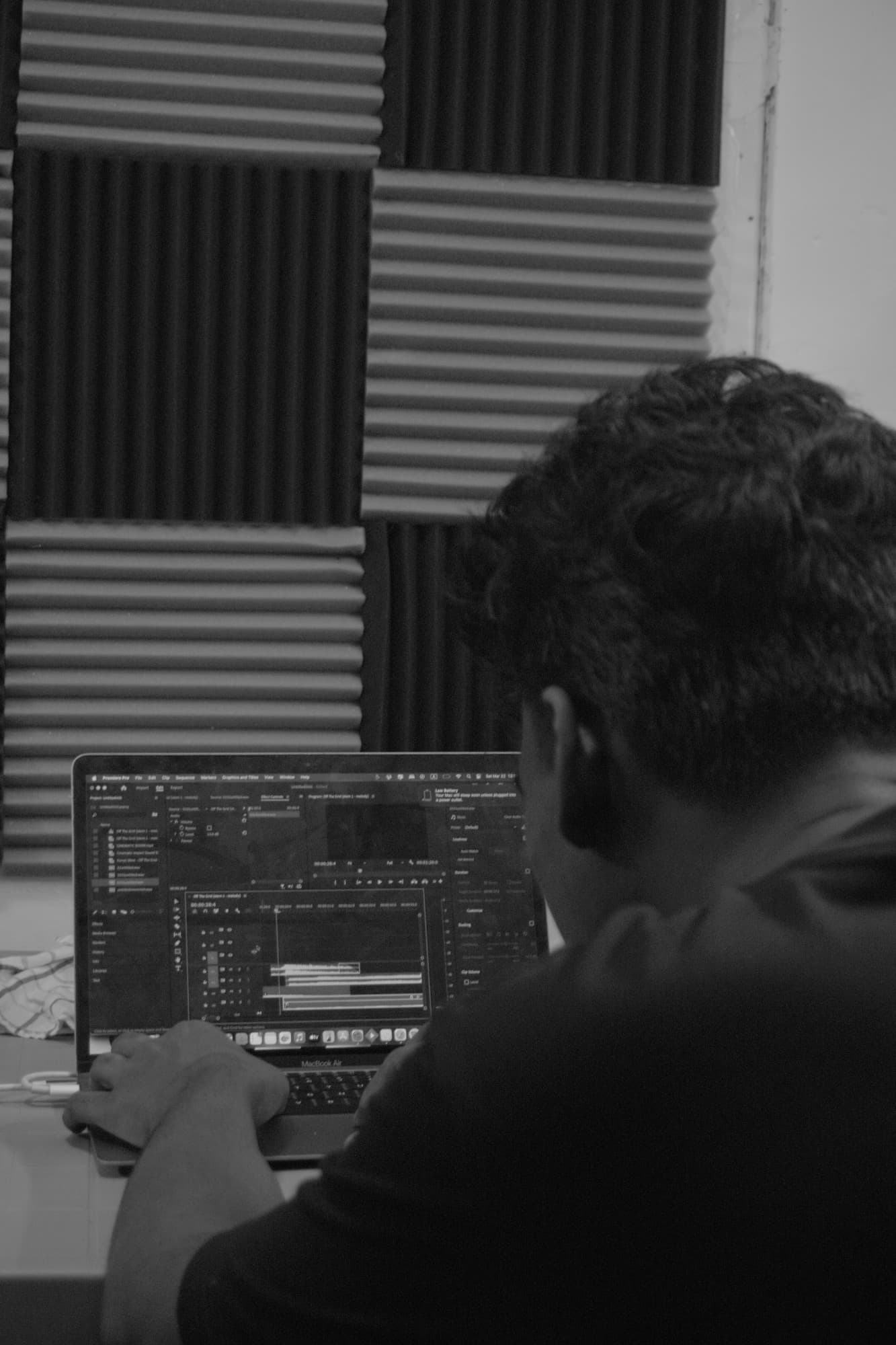 Cutting a sequence in Premiere Pro in a sound-treated edit room.