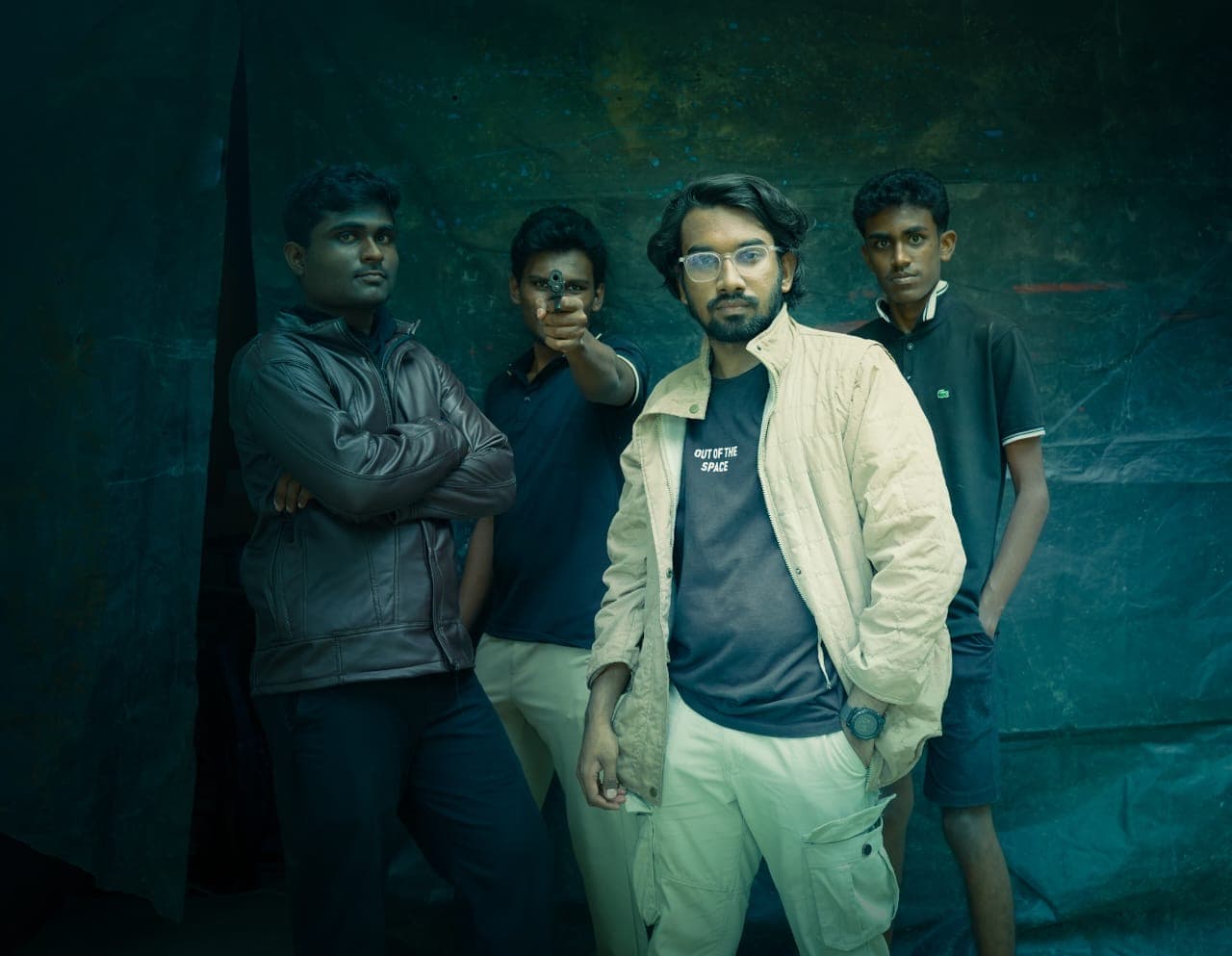 The cast photographed together against a painted backdrop.